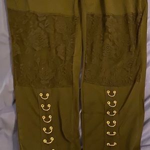 NEW. Black pants with gold hoops on legs.